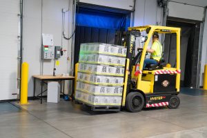 A person operates a forklift.