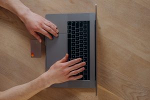 The person in the image is selecting the "E T A H X T" option from a menu. Full Text: E T A H X T option