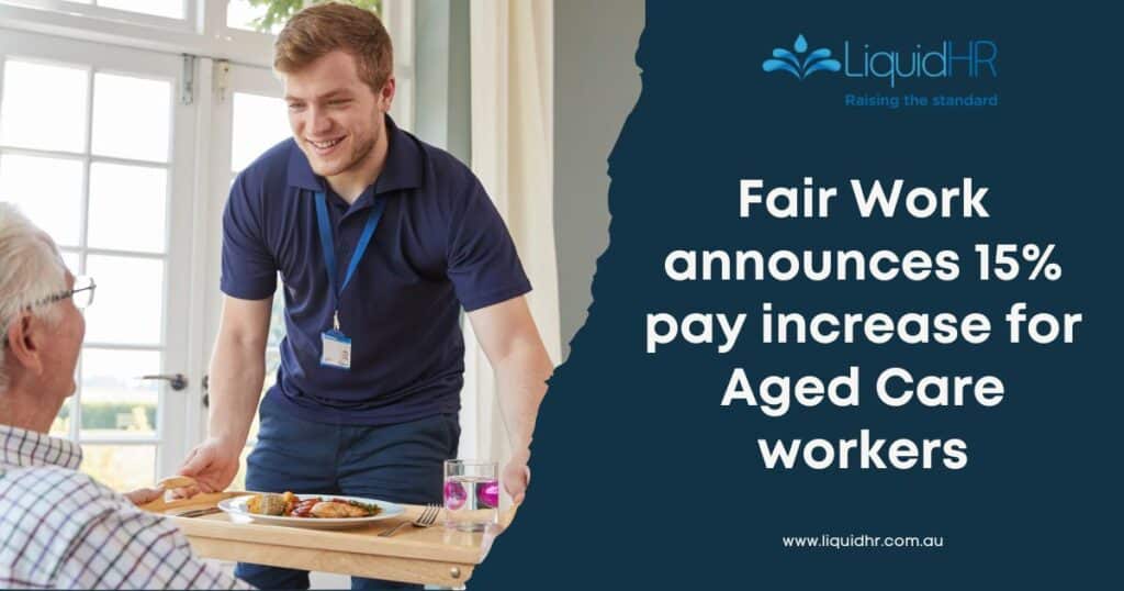 A nurse holds a plate of food while offering it to an older gentleman in an aged care facility.