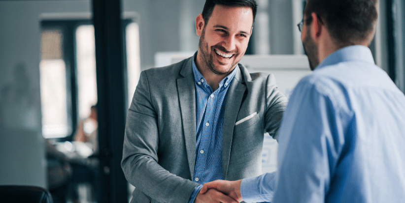Two professionals in conversation in a modern office setting, representing flexible and progressive workplace policies in Australia.