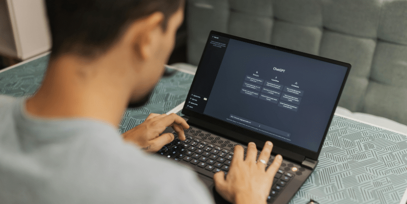 Person using a laptop displaying AI-powered HR software, representing the use of technology and automation in human resources.