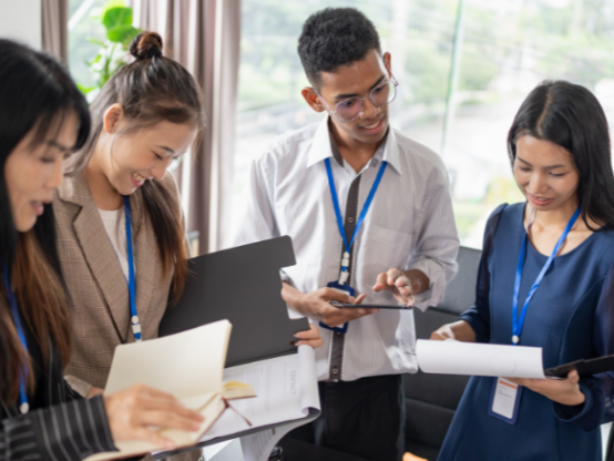 Team of professionals reviewing business documents, representing succession planning for SMEs