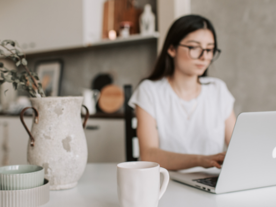 Woman working remotely from home on laptop, representing flexible work policies in Australia