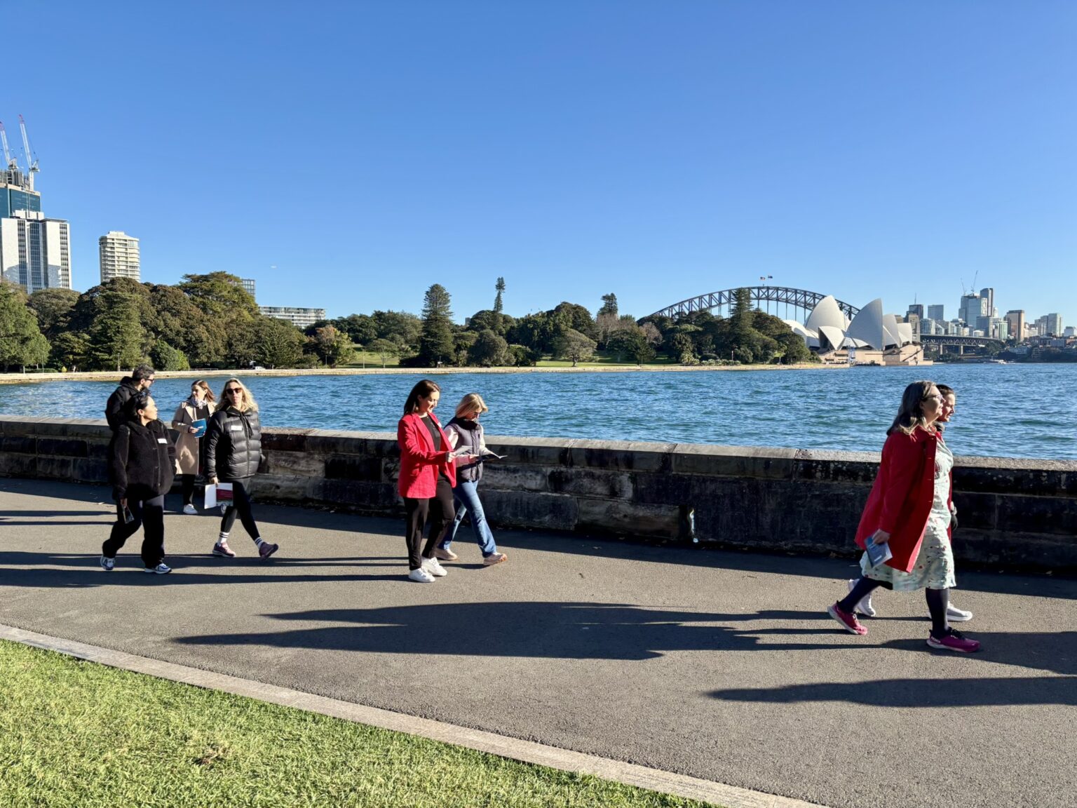 Business leaders walking along Sydney Harbour during Leadership Walk Sydney event