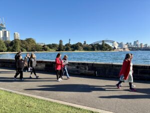 Business leaders walking along Sydney Harbour during Leadership Walk Sydney event