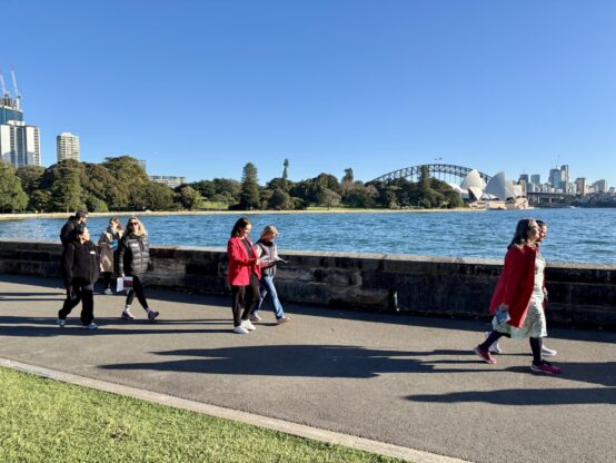 Business leaders walking along Sydney Harbour during Leadership Walk Sydney event