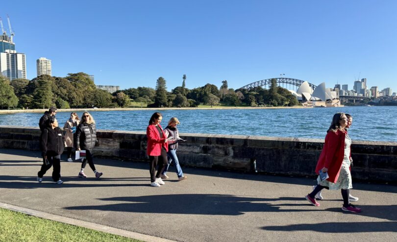Business leaders walking along Sydney Harbour during Leadership Walk Sydney event