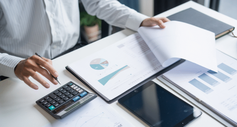 Person reviewing HR documents and records during a HR compliance audit, including contracts, payslips and Fair Work requirements.