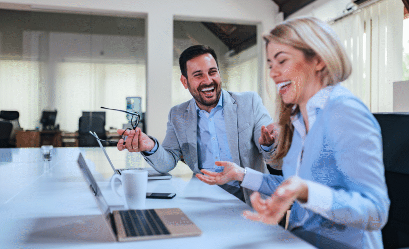 Why hire an hr contractor, Two professionals smiling during a business meeting