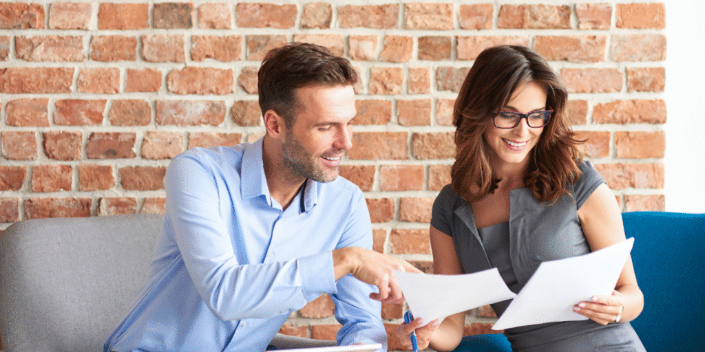 Small business owners reviewing HR documents as part of HR support for small businesses