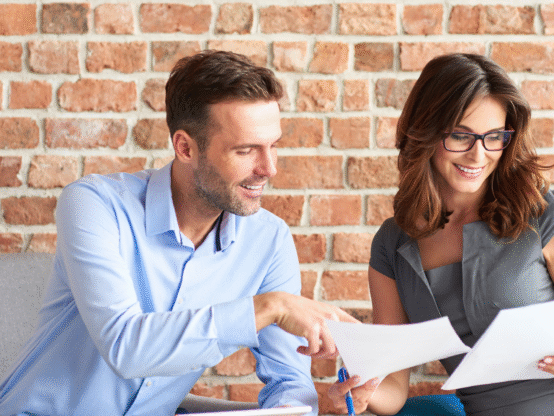 Small business owners reviewing HR documents as part of HR support for small businesses